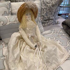Blonde Doll in a white dress with straw hat